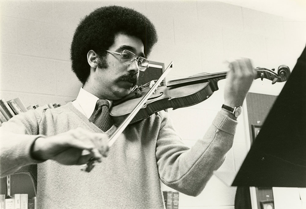 Paul Burgett playing the violin during his teaching days