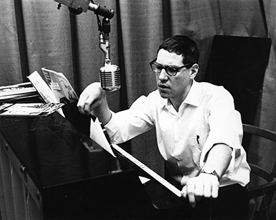 archival photo of Jim Carrier sitting at a piano