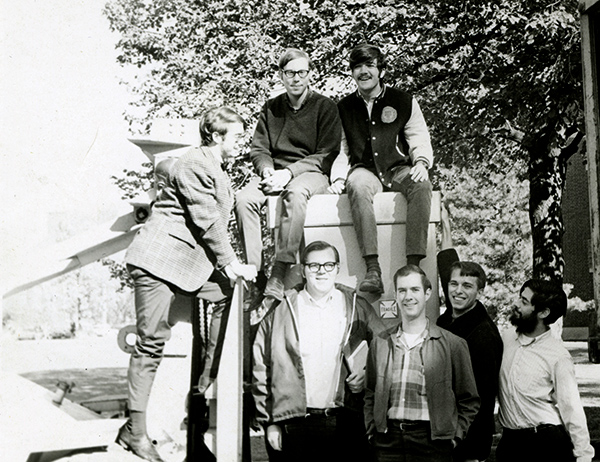 large group of students pose for a photo next to a large crane that delivered a new stero transmitter