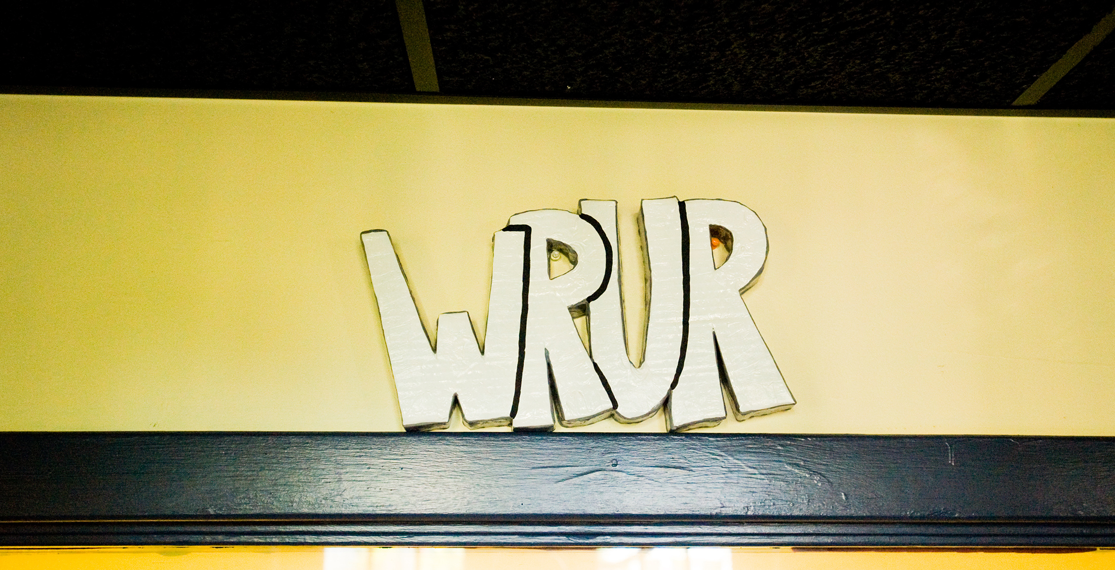 station letters WRUR carved in wood
