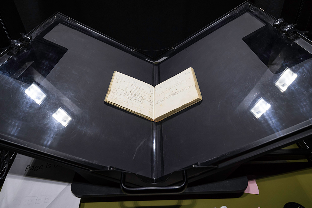book on a stand, being digitized