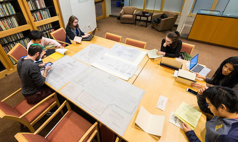 group of students sitting around a table in Rush Rhees Library