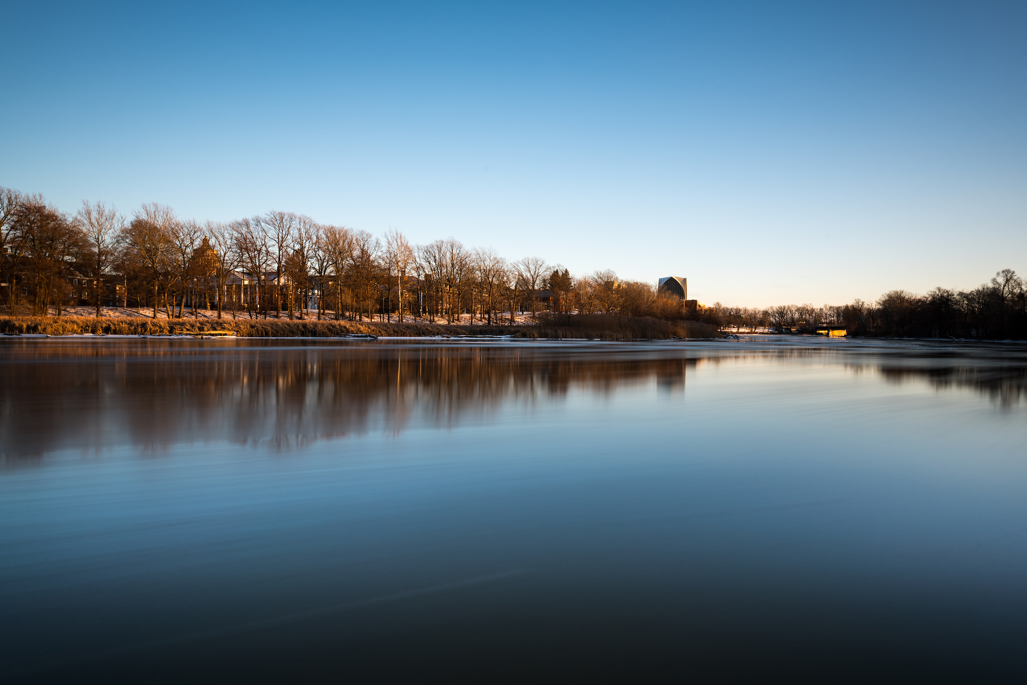 Ice floes float past University of Rochester’s River Campus along the Genesee River during a long exposure at sunset