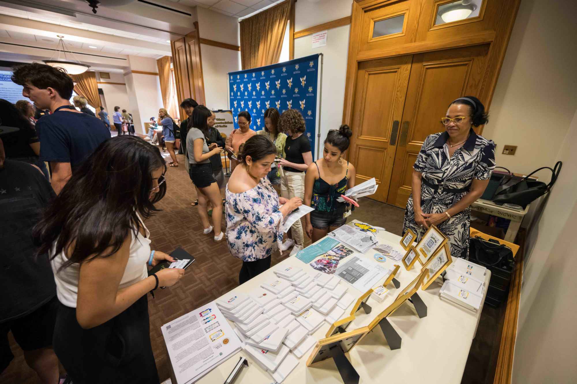 First generation students and their families peruse resources and materials on display during an on-campus reception for them.