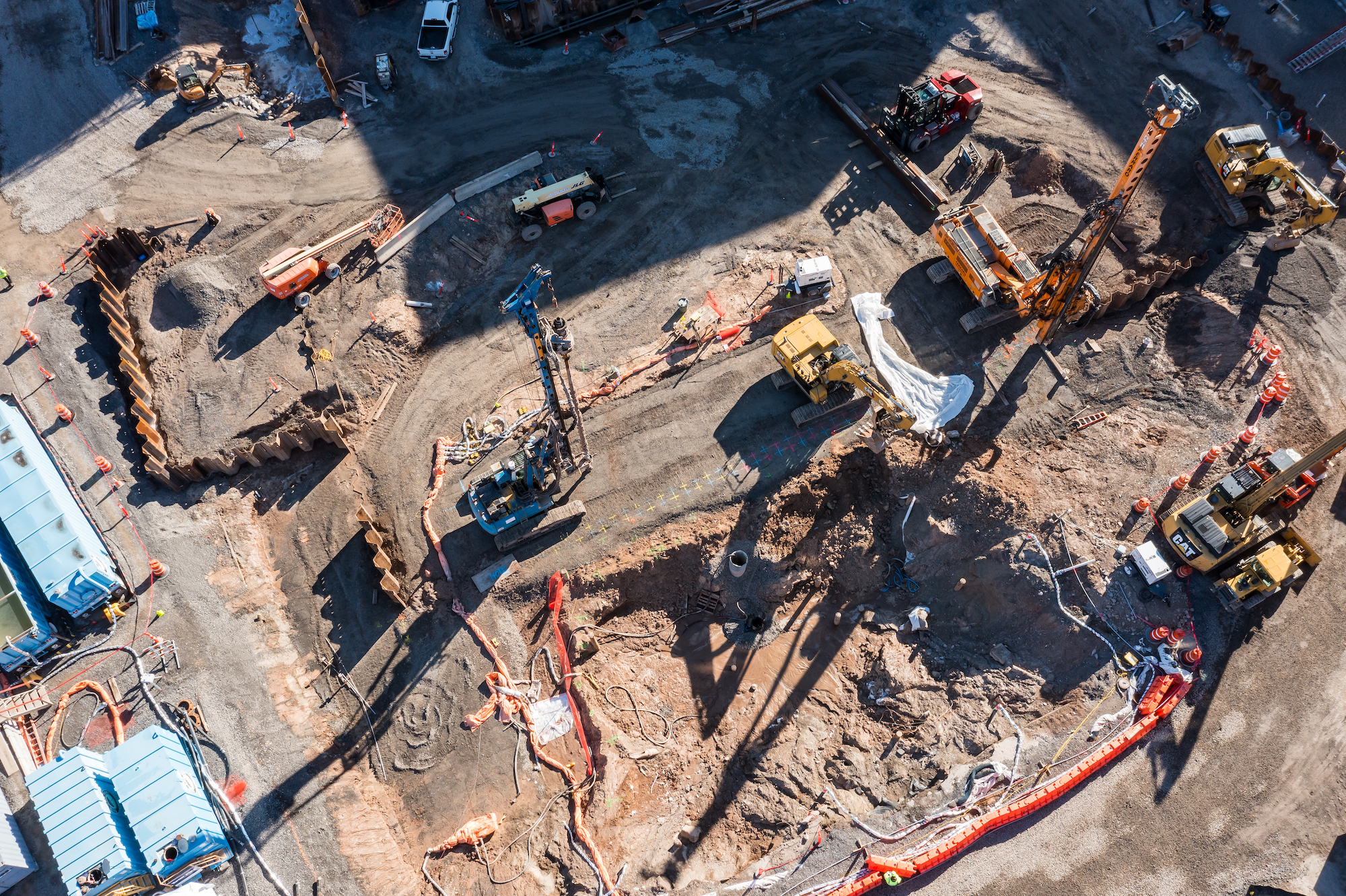Aerial drone photo of various construction vehicles at construction site