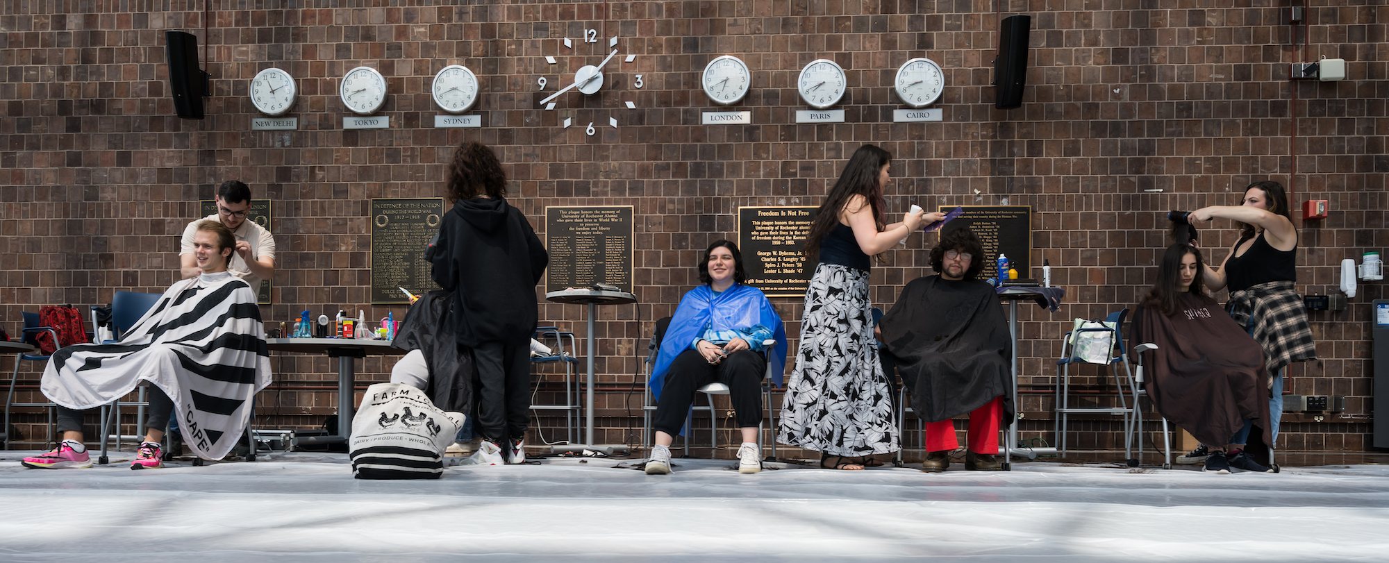 Five students are given haircuts and hairstyles