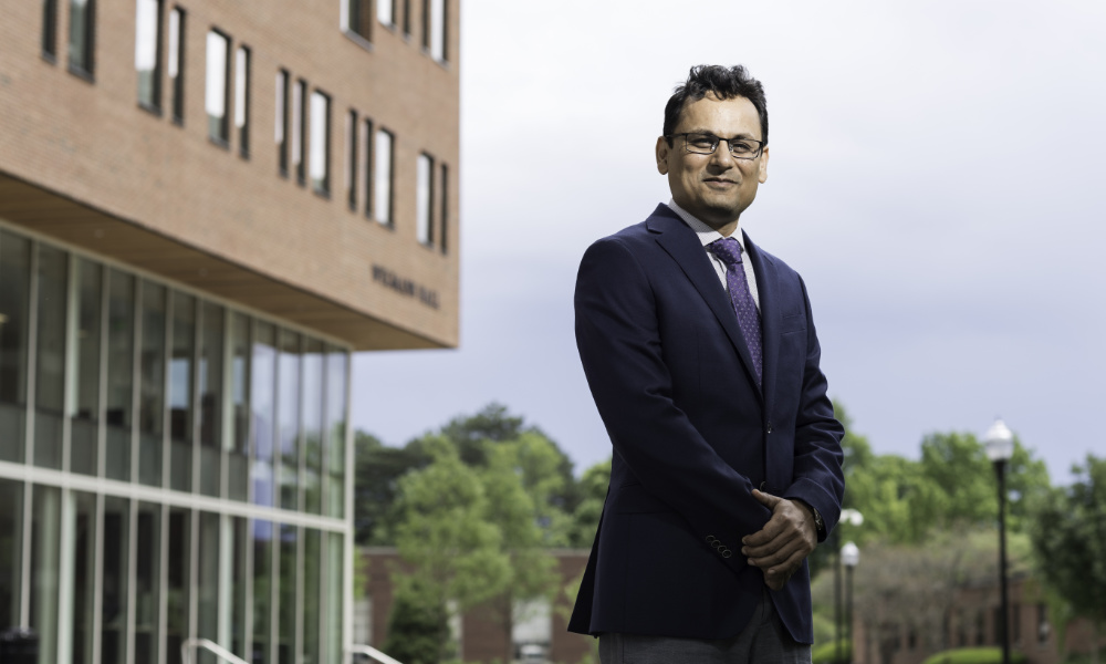 Ehsan Hoque stands in front of Wegmans Hall.