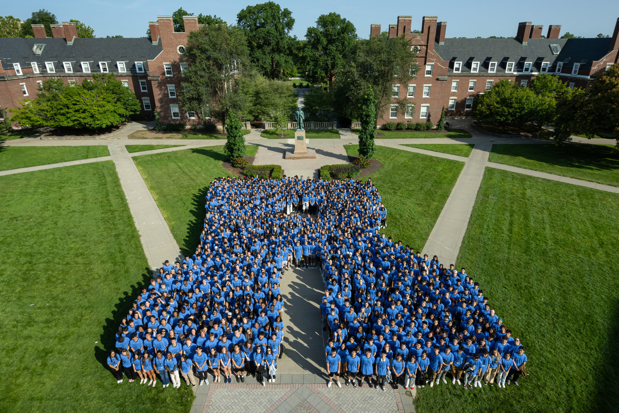 Class of 2028 form a blue "R" on the Wilson Quad