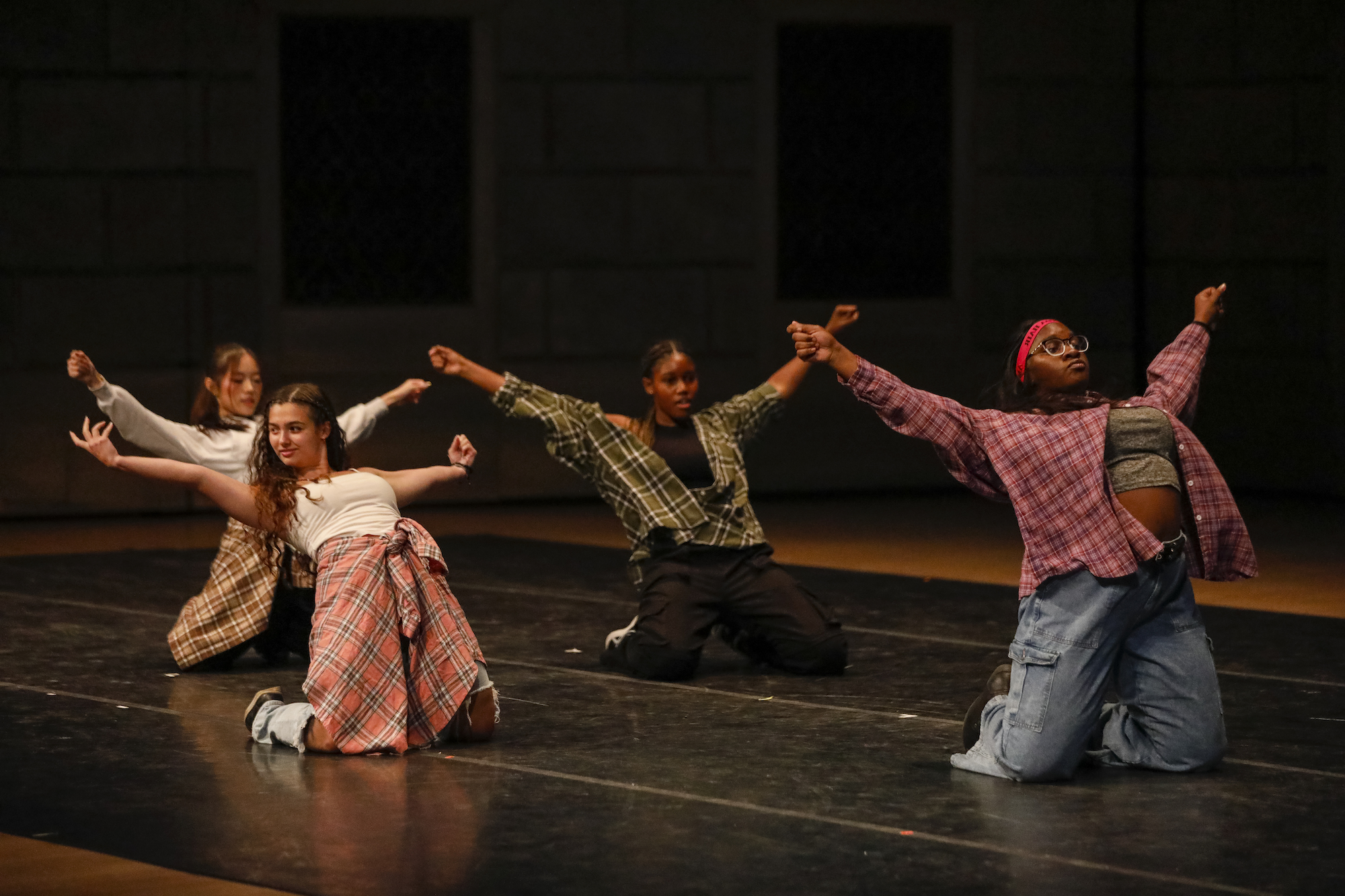 Four members of dance group Undulgence perform on stage