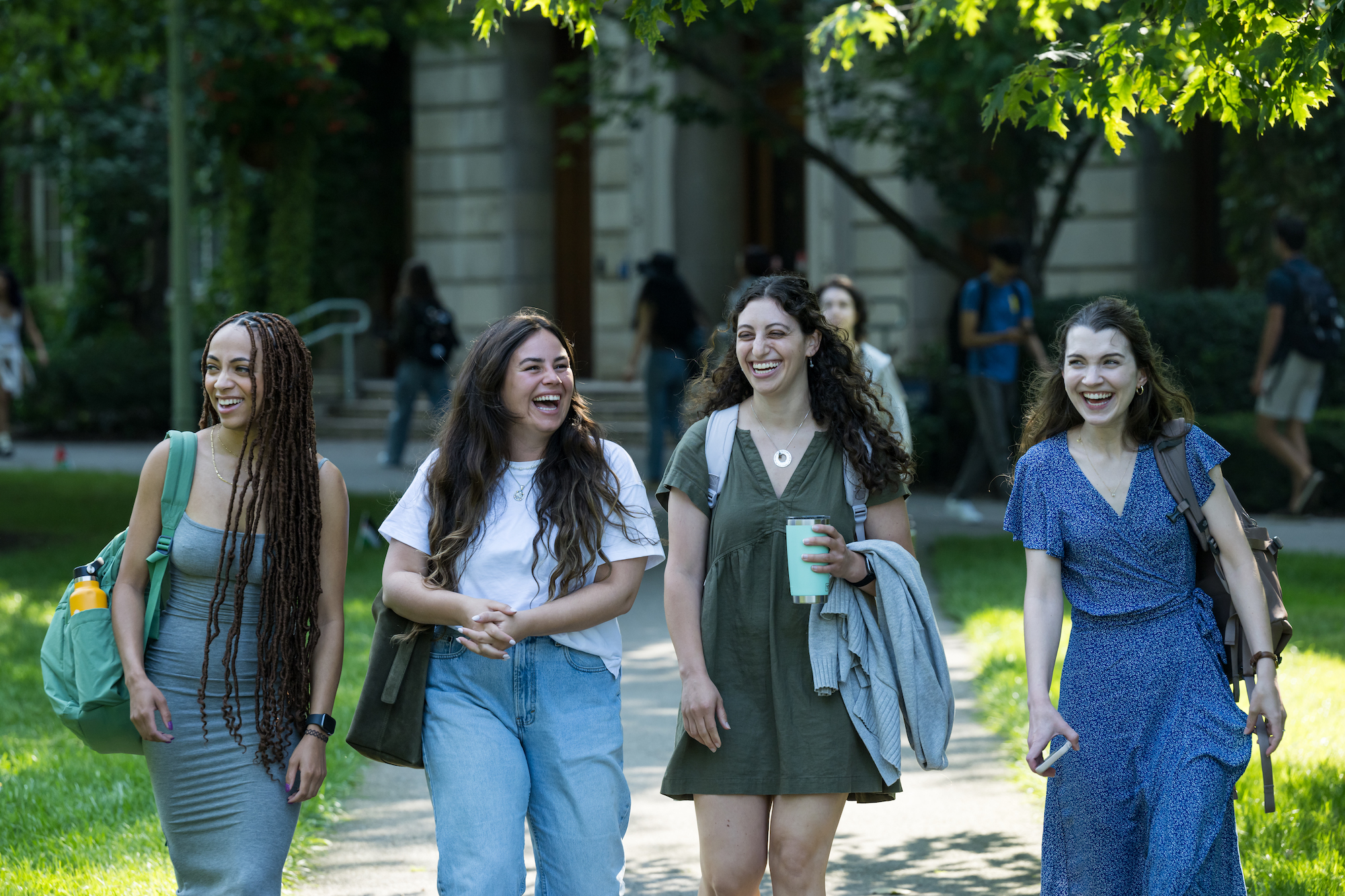Four students walk to class on a fall day