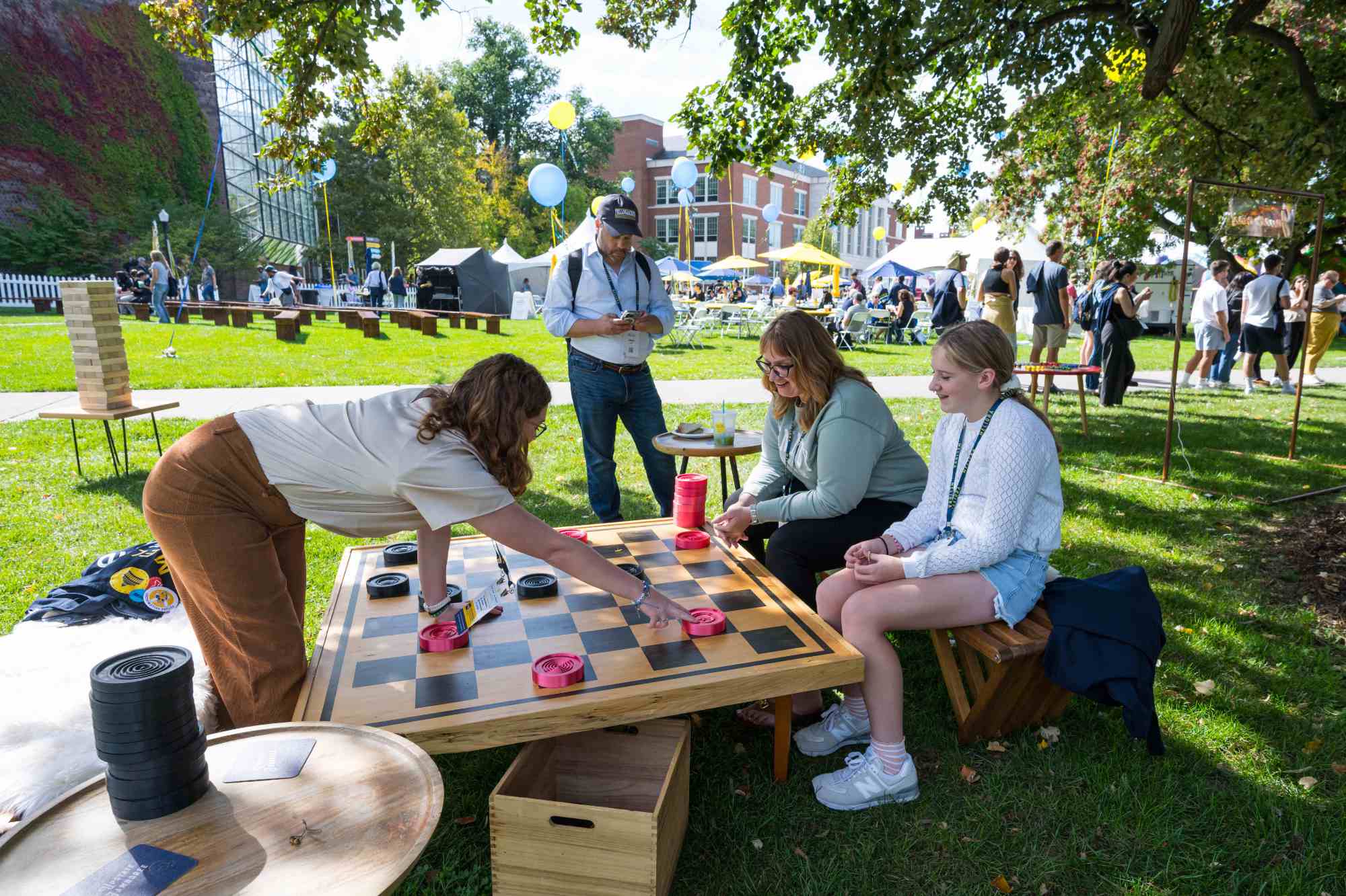 People playing a game of giant checkers on the Wilson Quad.