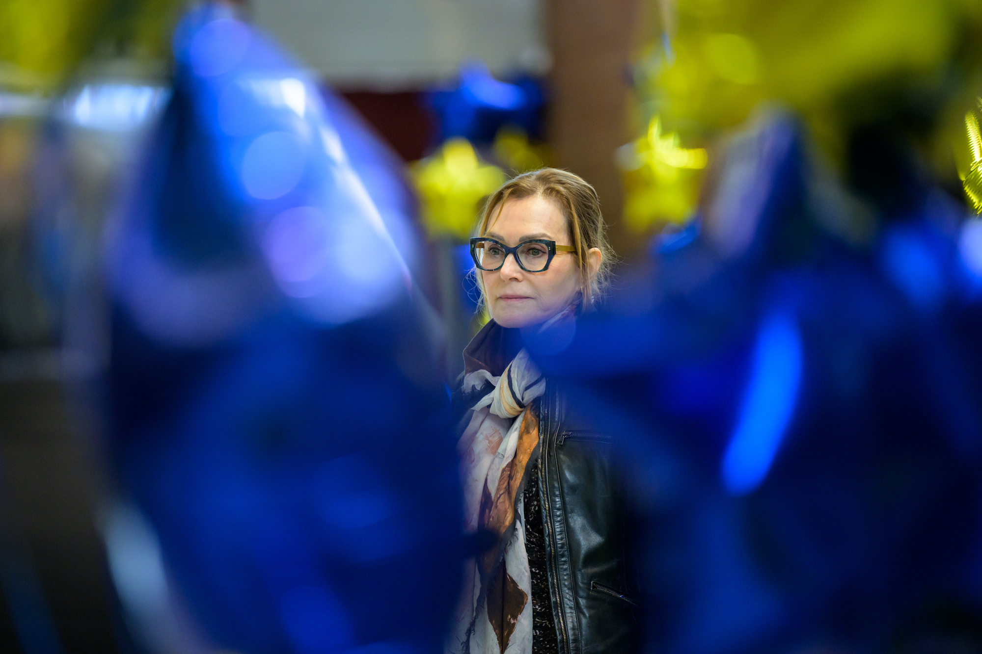 Lynne E. Maquat is photographed among gold and blue star balloons