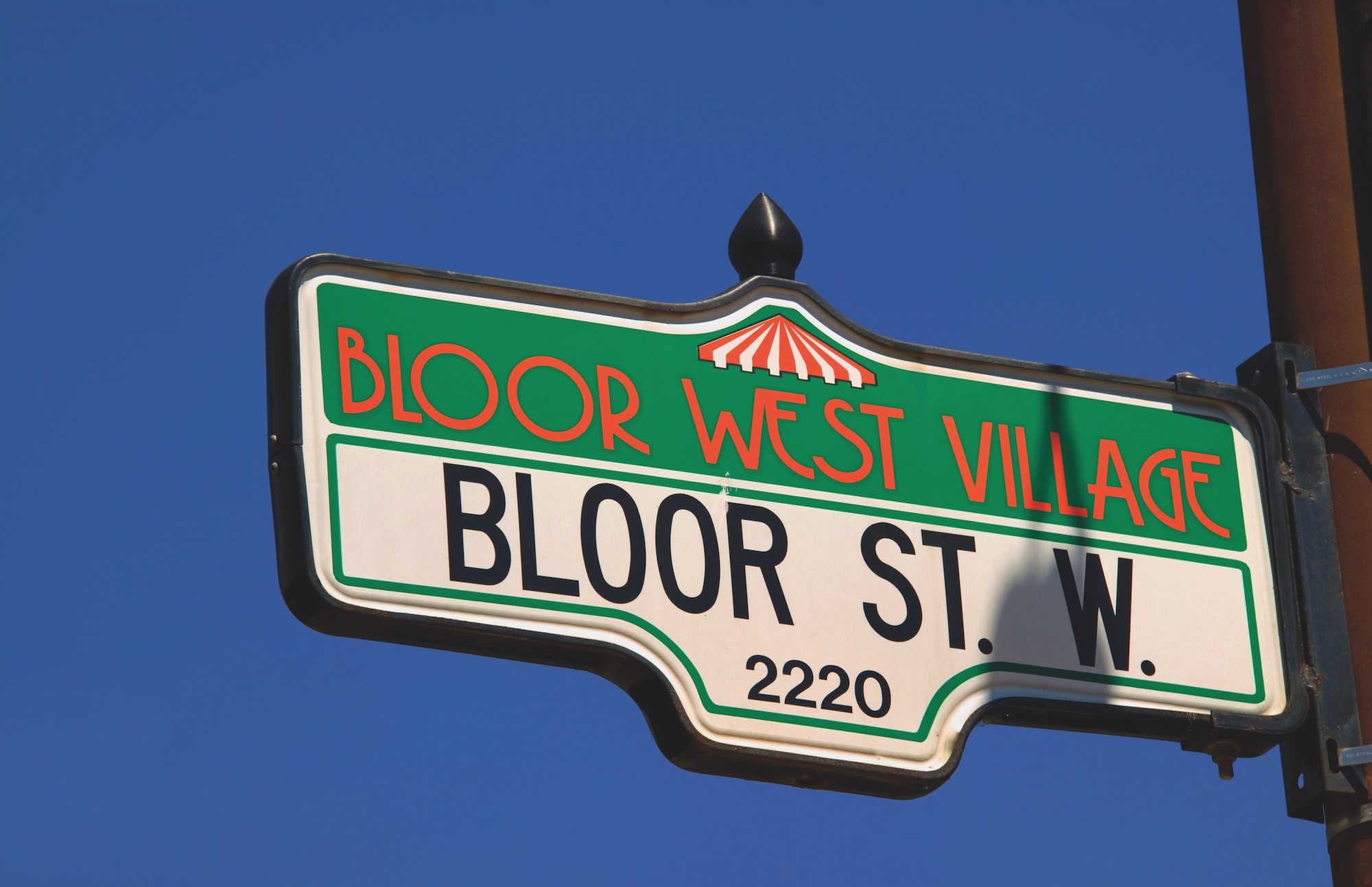 Bloor Street sign against deep blue sky.