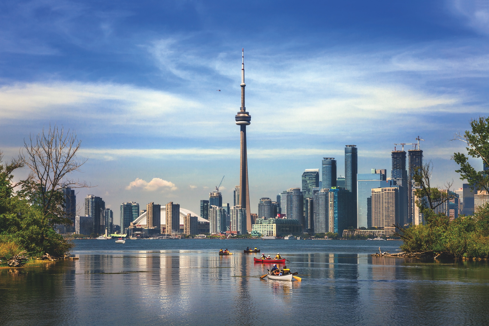 Toronto skyline with CN Tower in center and Lake Ontario in foreground.