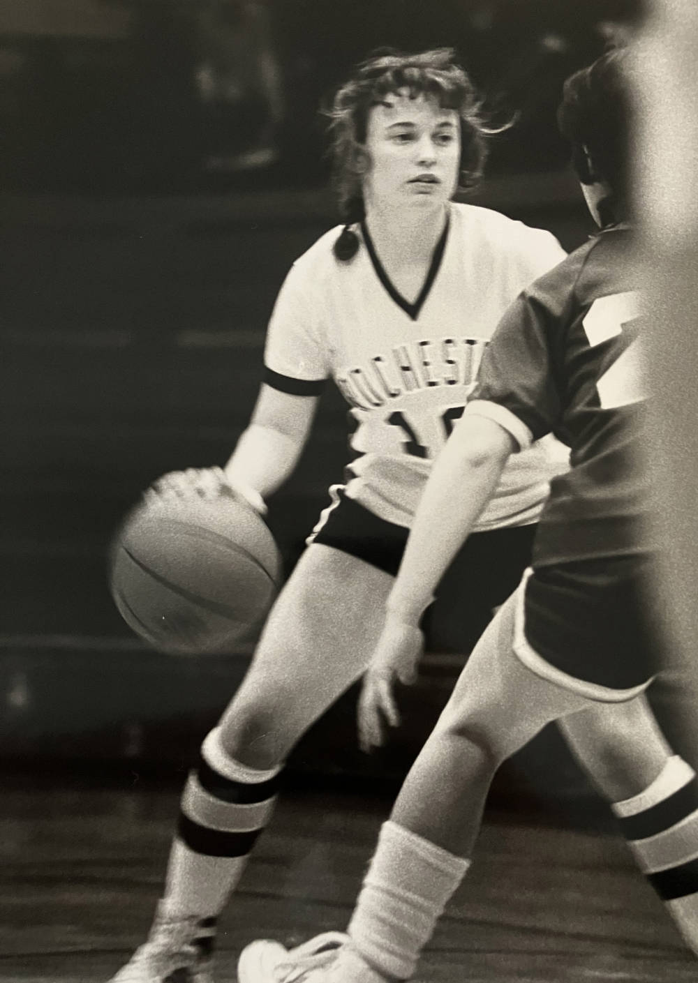 Black and white archival photo of Karen Durkin playing basketball at the University of Rochester.