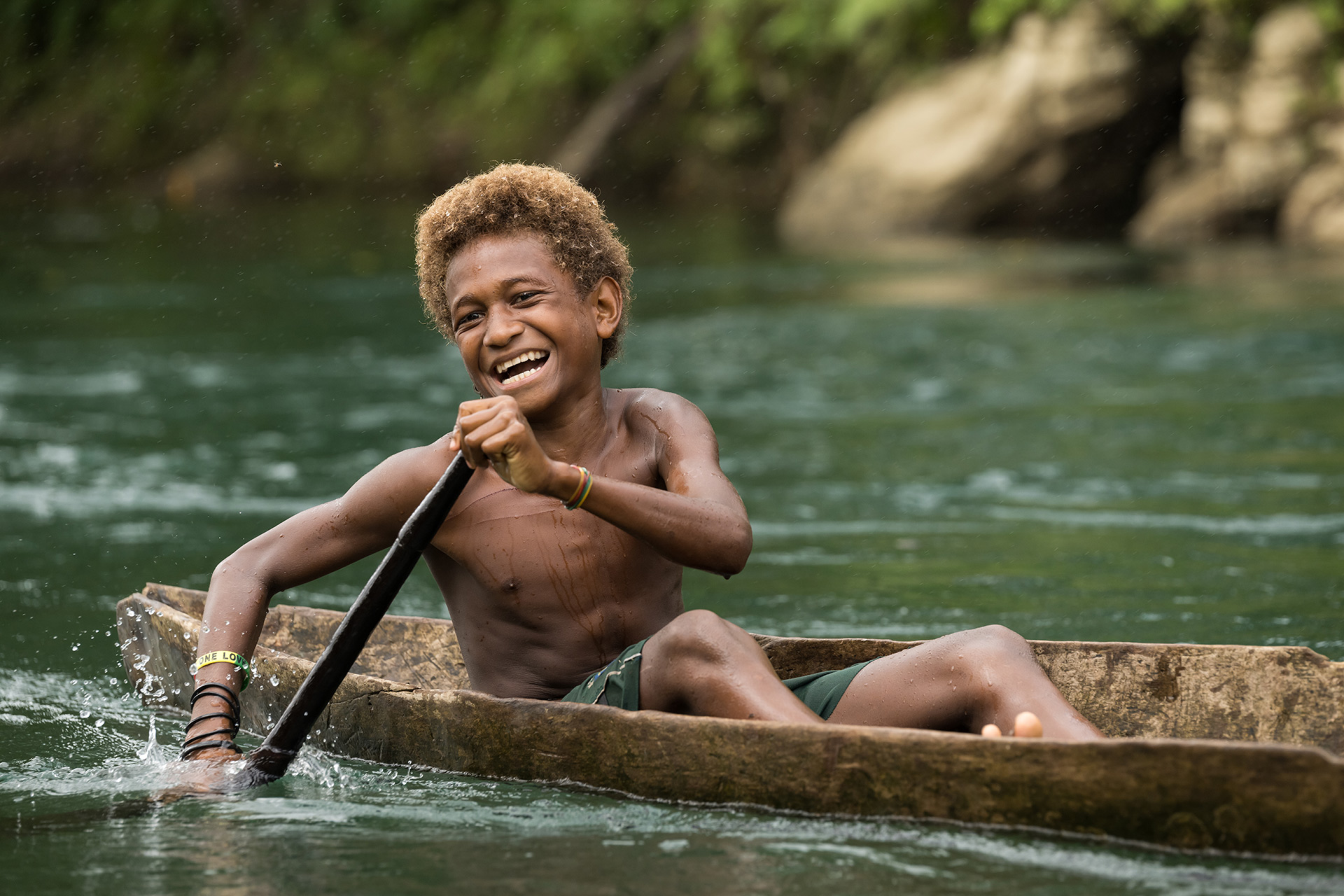 bow smiles while paddling a canoe