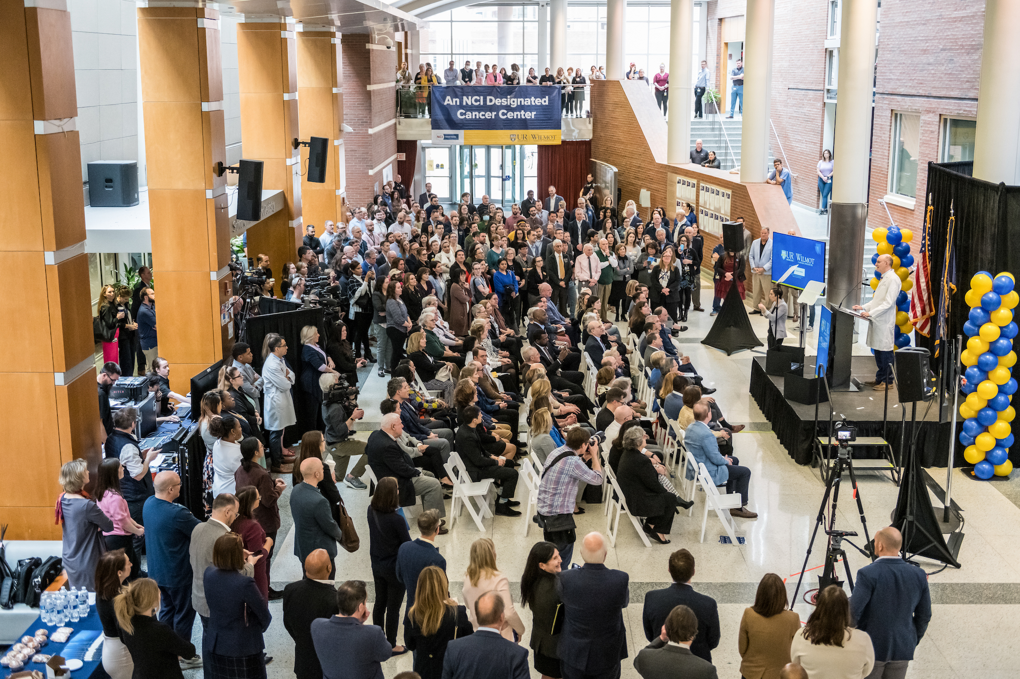 Overhead shot of a press conference announcing Wilmot Cancer Institute as an NCI-designated cancer center.