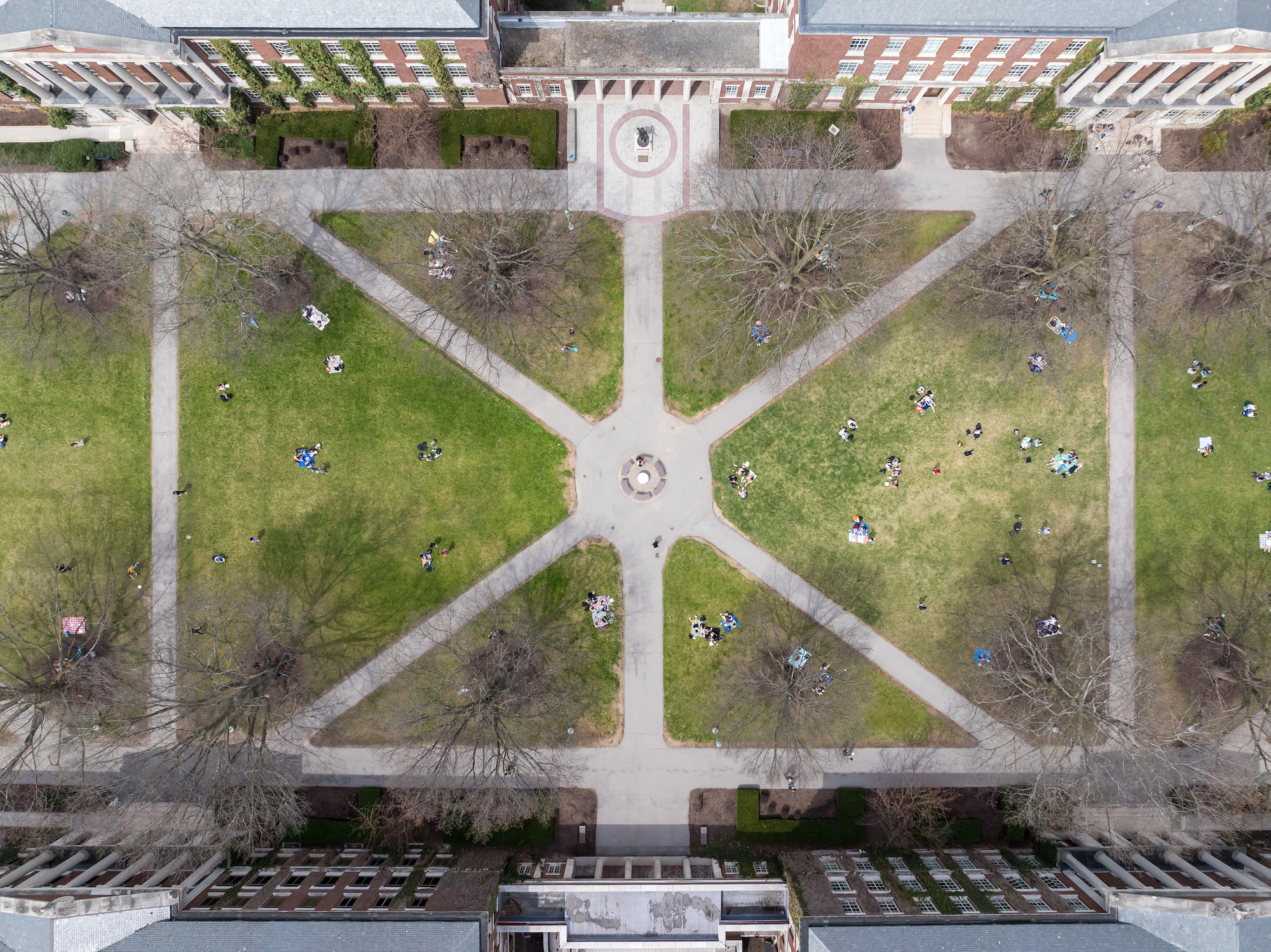 Students, seen from above via aerial drone, enjoy a warm afternoon on Eastman Quad. 