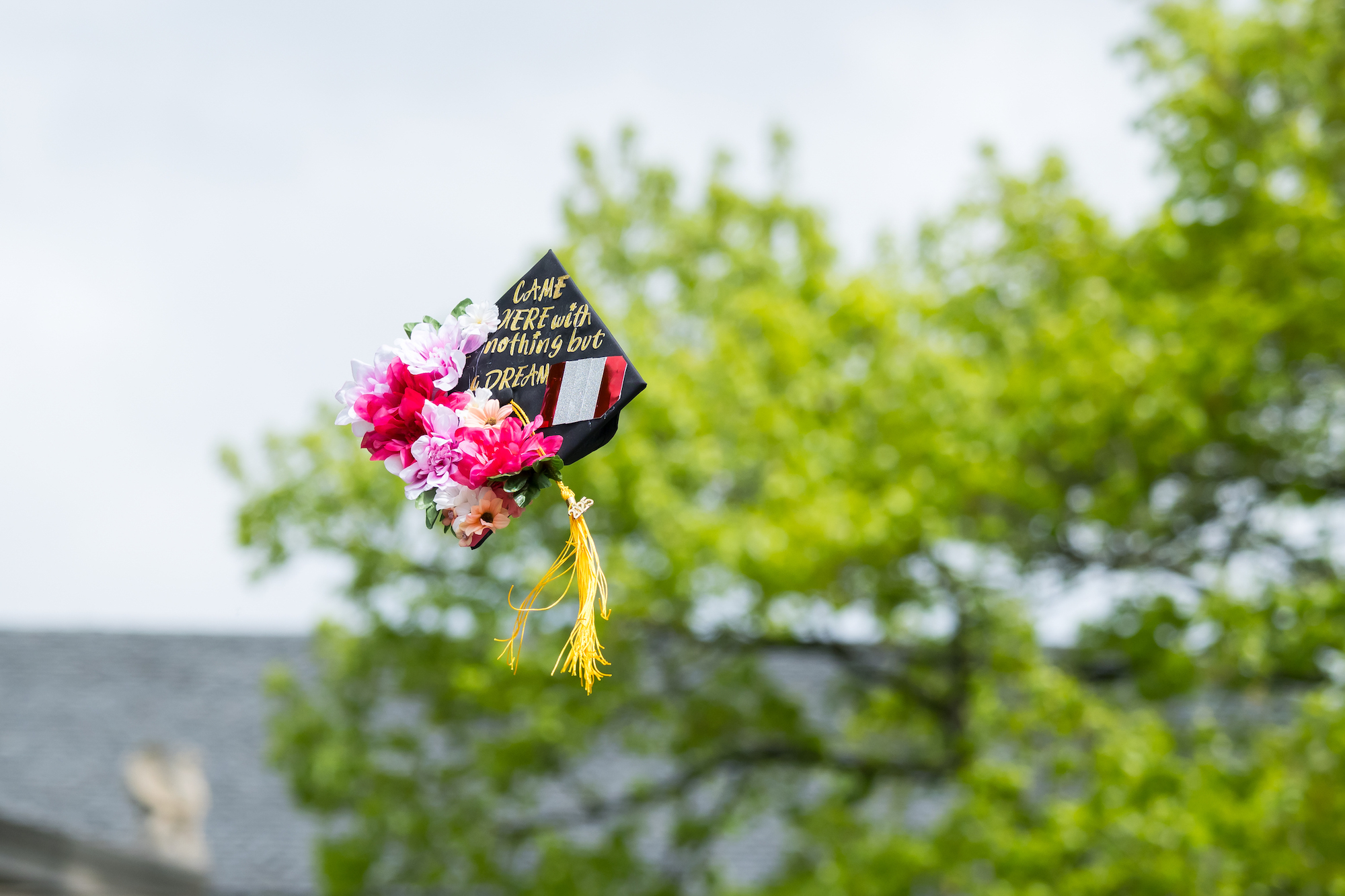 A mortarboard flies through the air.
