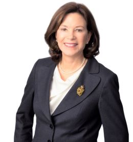 professional portrait of woman wearing a dark blazer.