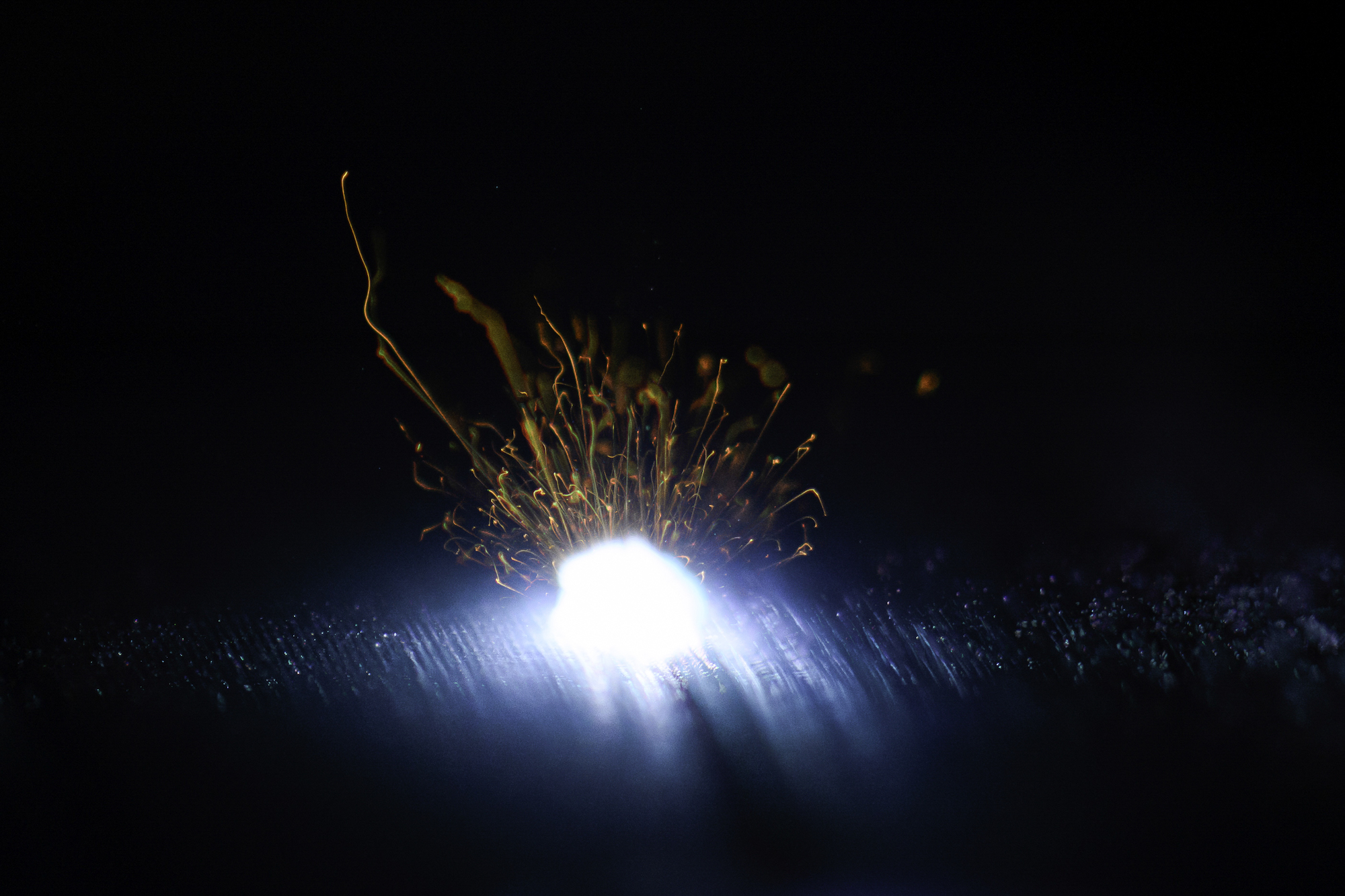 A laser etches nanostructures into a highly absorbant black metal surface.