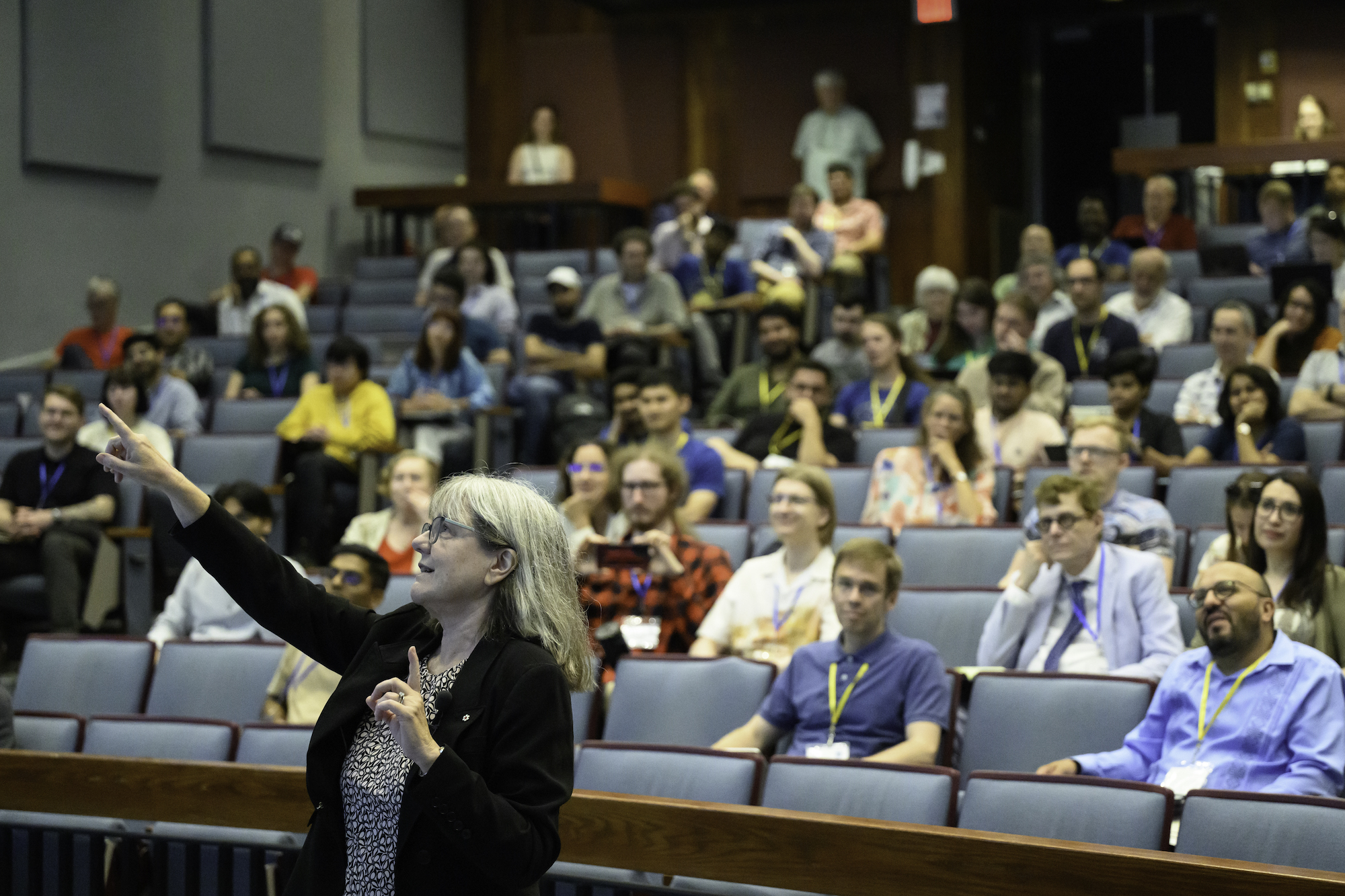 Donna Strickland gives a keynote address in a full auditorium.
