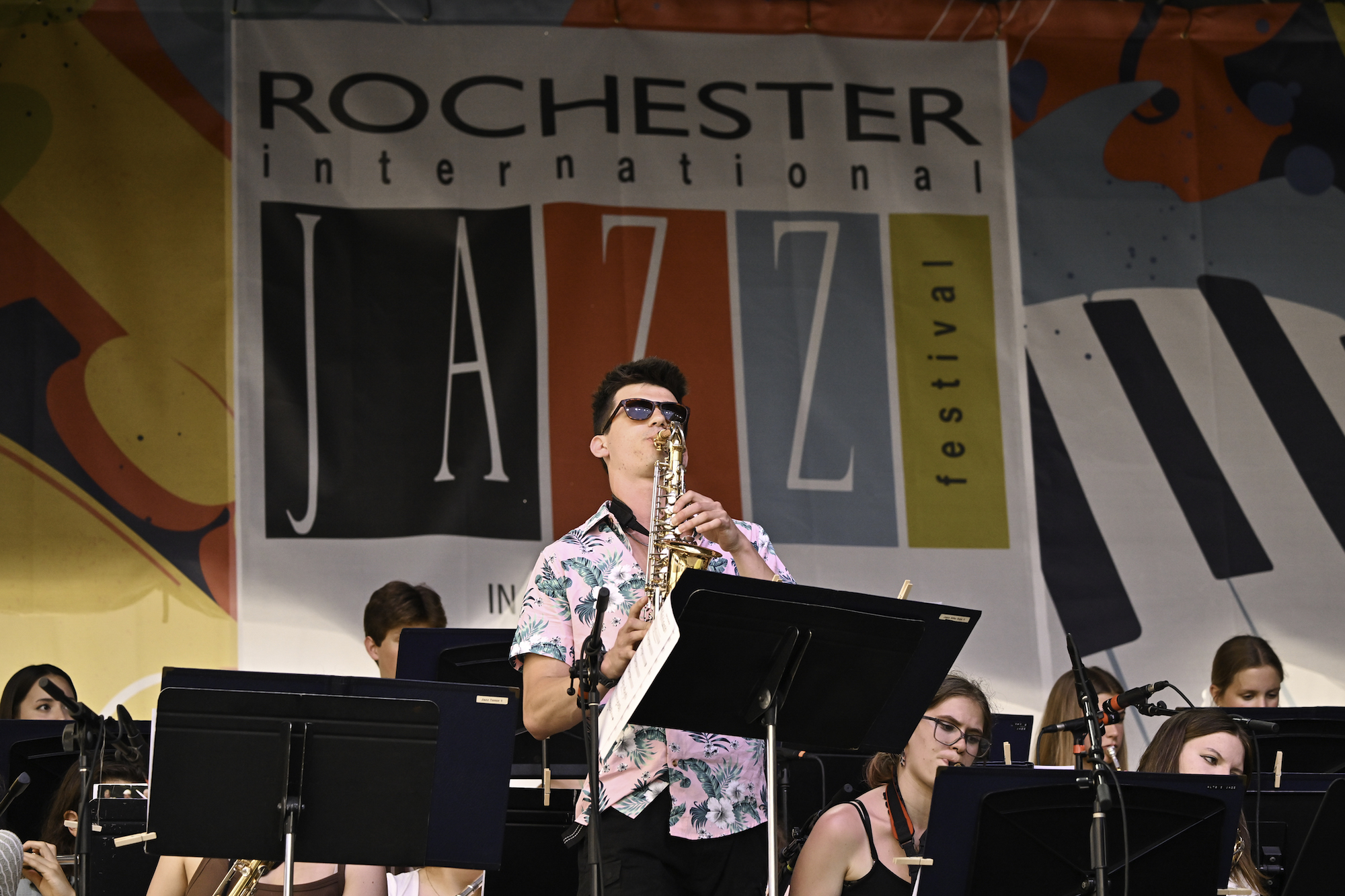 High school student plays a saxophone solo with a jazz band.