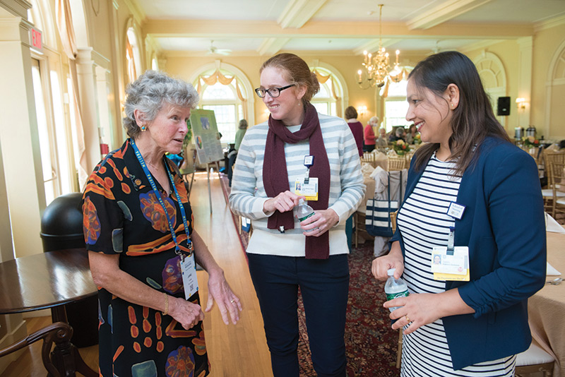photo of University of Rochester nursing students talking with a nursing professor at an open house session on research at the school of nursing