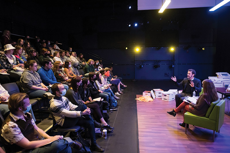 photo University of Rochester students and parents listening to Pulitzer Prize winning playwright Tony Kushner in a campus theater