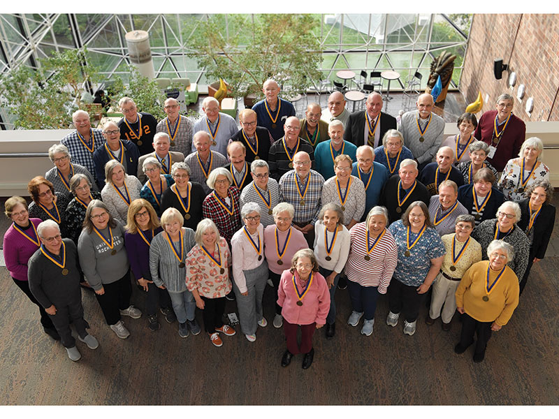 photo of University of Rochester alumni from the class of 1972 gathered in the student union for a group photo