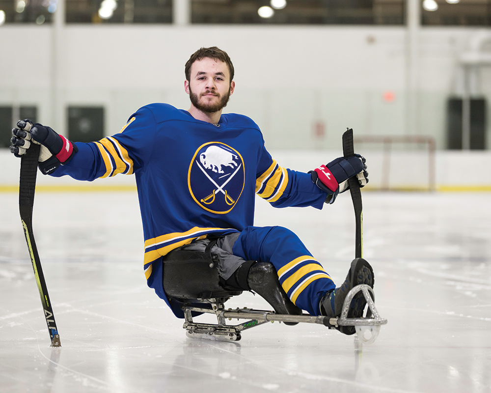 photo of Rochester student Sam Becker playing sled hockey