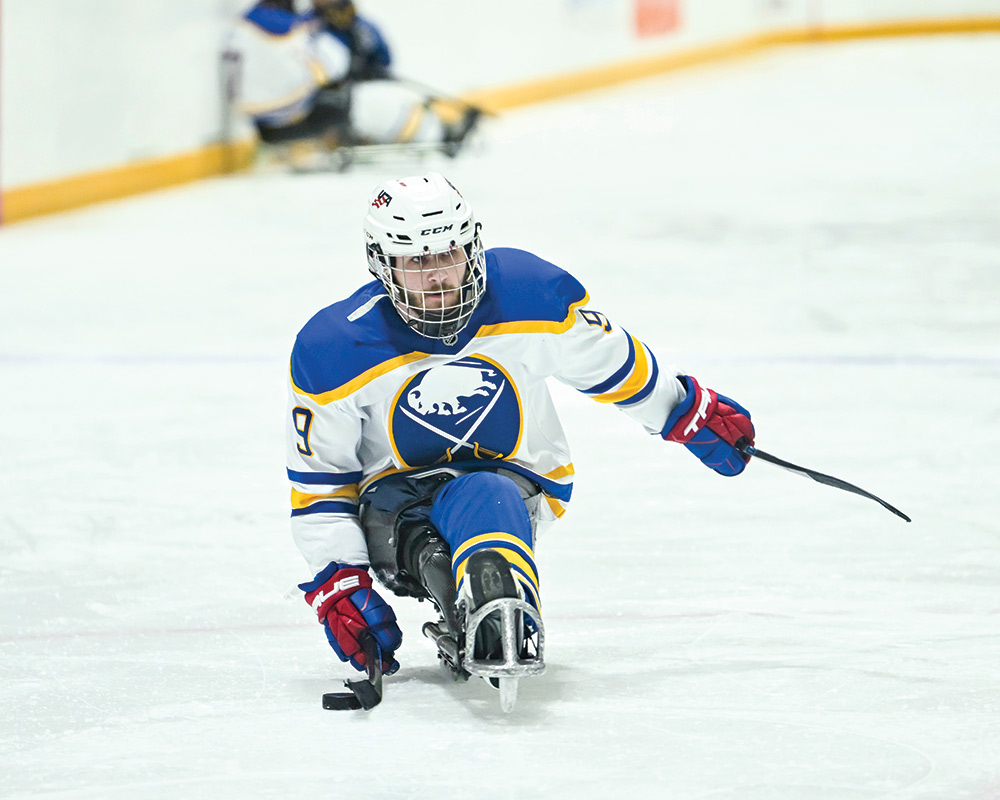 photo of Rochester student Sam Becker playing sled hockey
