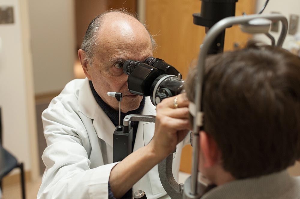 doctor examines eyes of patient