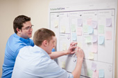 students writing on a white board