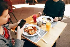 Two people at a table eating breakfast