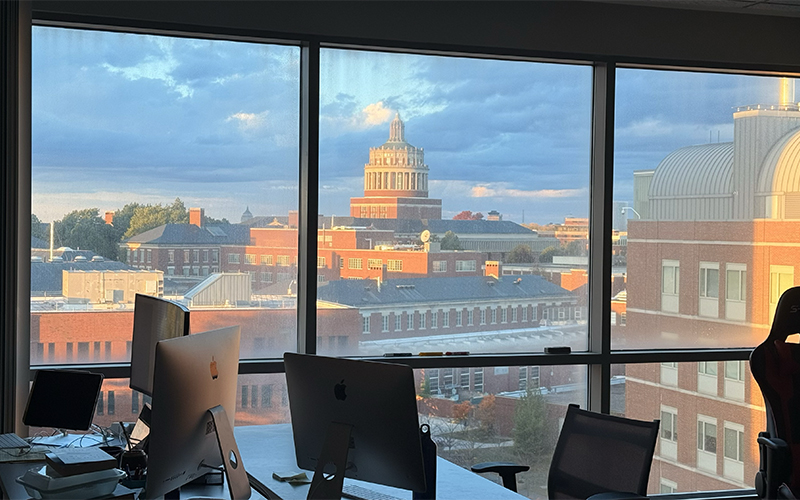 An aerial view of campus as seen through a window at golden hour.