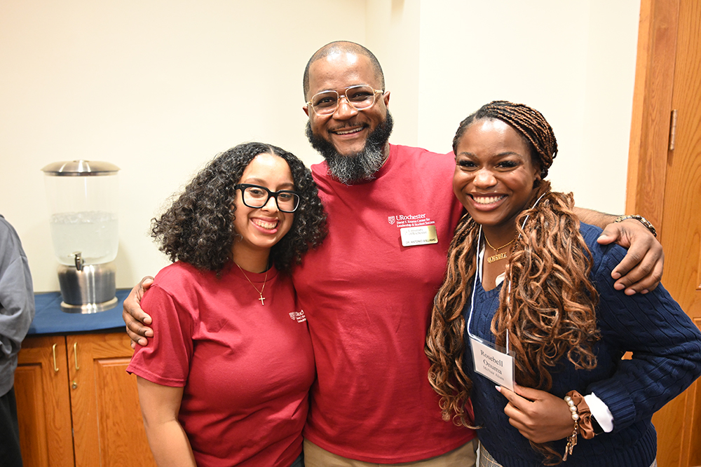 Three people smiling at the camera.