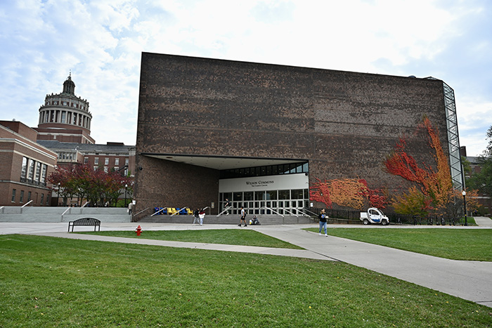 An exterior view of the Wilson Commons building with students walking by.