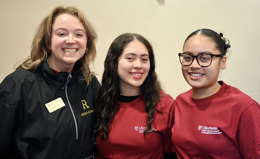 Three people smiling at the camera.
