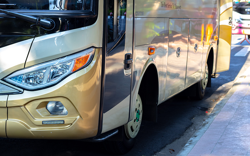 Photo of a shuttle bus sitting next to a curb