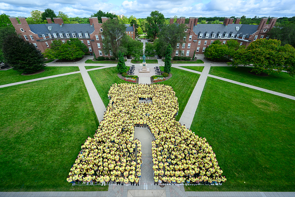 New fall 2026 students pose in the shape of an R on Wilson Quad