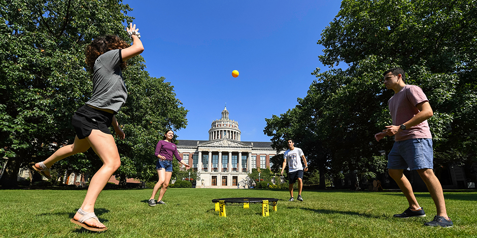 Students walking and talking on Wilson Quad.