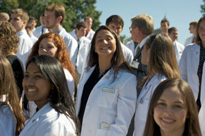smiling students in white coats