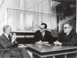 Norman Neureiter talking with others at table