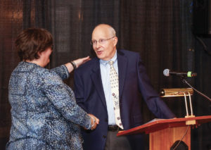 Gloria Culver awarding medal to Neureiter