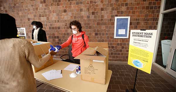 handing out masks in Wilson Commons