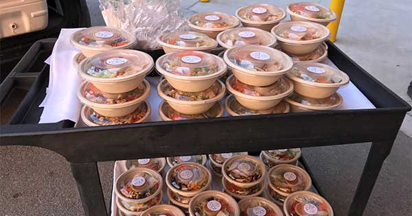 moving cart full of prepackaged meals