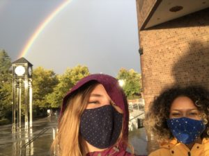 Matulonis and friend on campus with rainbow in the background