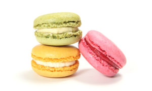 Photo of three Macarons. one green, another pink, and the last yellow
