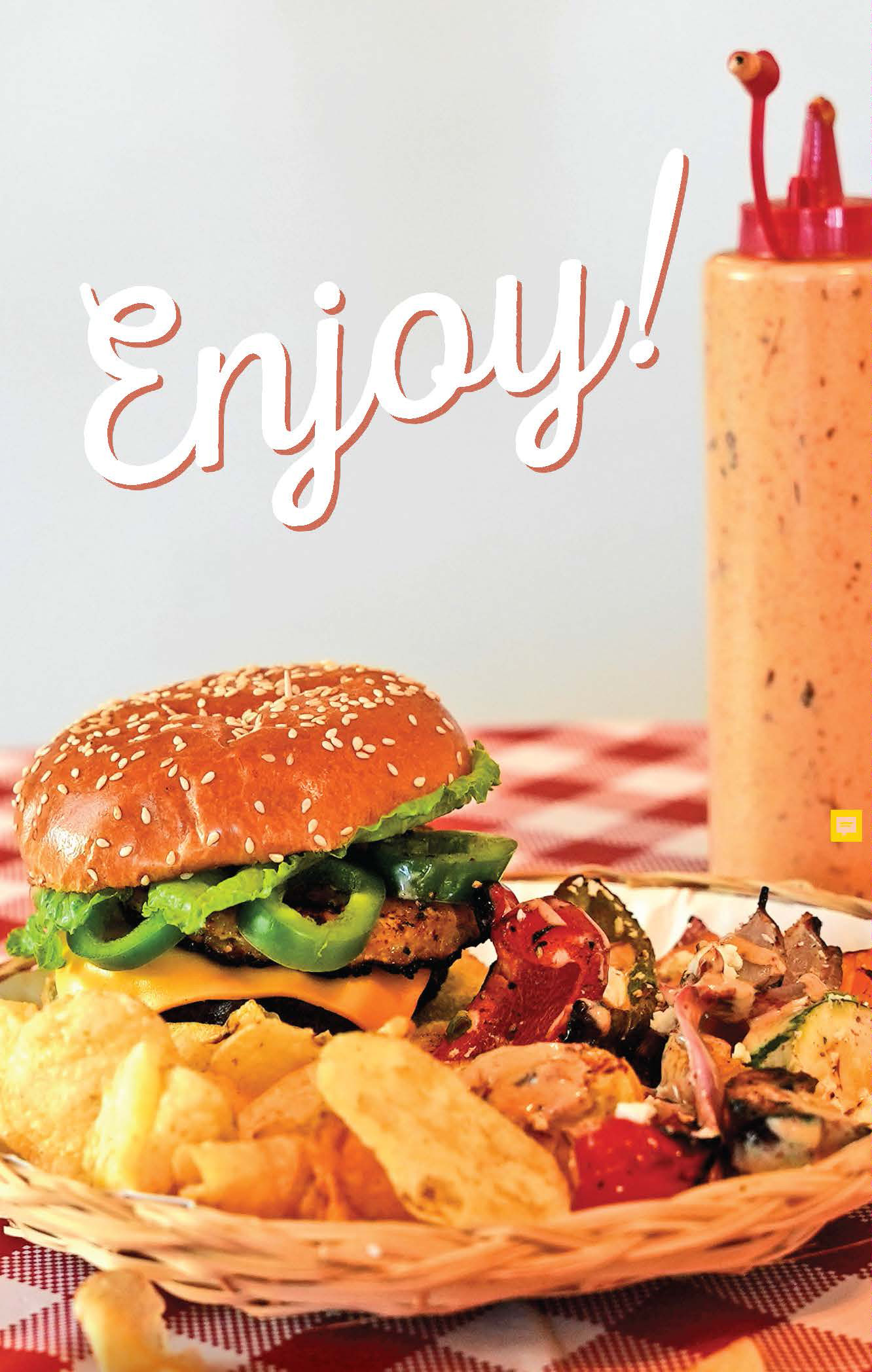 Burger and chips on plate with bottle of sauce